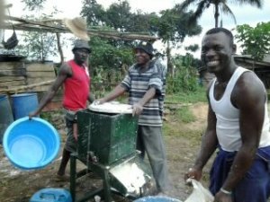 Entrepreneurial teachers setting up the grinding of cassava tubers for students to take over.